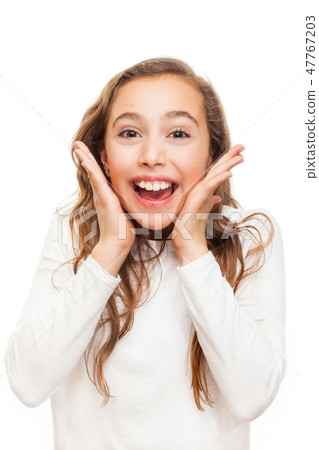 Smiling young girl looking happily surprised Smiling young girl looking happily surprised 47767203