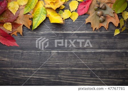 Autumn Leaves And Acorns On Wooden Table 47767781