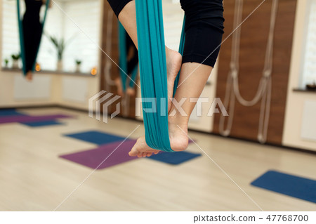 close up Woman legs stay in hammock doing fly yoga close up Woman legs stay in hammock doing fly yoga 47768700
