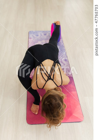 young woman in a sportswear yoga exercises with young woman in a sportswear yoga exercises with 47768703
