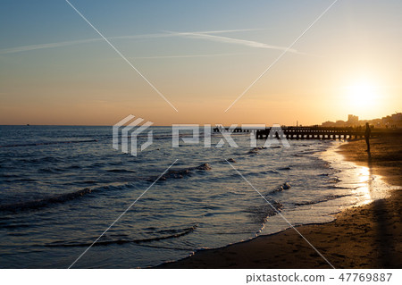 Beach at dawn, piers perspective view 47769887