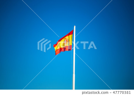 Spanish flag on the blue sky without clouds 47770381