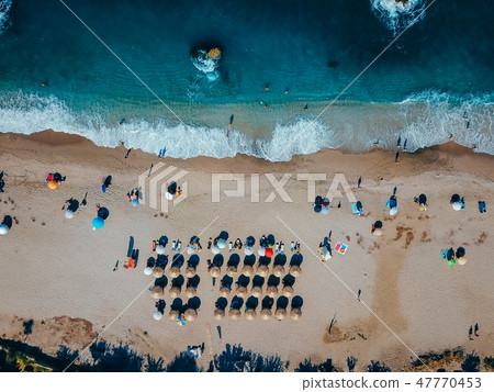 Beach with sun loungers on the coast of the ocean Beach with sun loungers on the coast of the ocean 47770453