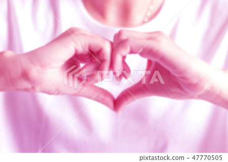 Blurry hand signs to be heart shape; showing love. Blurry hand signs to be heart shape; showing love. 47770505