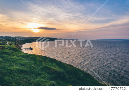 Hilly shore next to the rivers estuary Hilly shore next to the rivers estuary 47770712