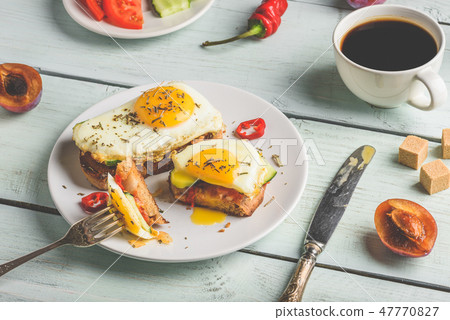 Bruschettas with vegetables and fried eggs 47770827