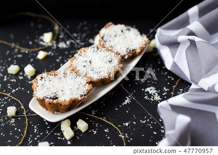 coconut muffins on a black background 47770957