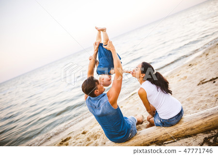 Theme family weekend, beach summer vacation with child. Young stylish family of three dad mom and Theme family weekend, beach summer vacation with child. Young stylish family of three dad mom and 47771746