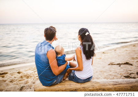 Theme family weekend, beach summer vacation with child. Young stylish family of three dad mom and 47771751