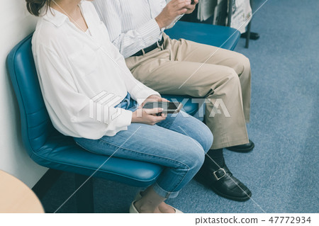 heterosexual couple, chair, cell phone 47772934