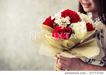 Happy woman holding rose gift on Valentines day. Happy woman holding rose gift on Valentines day. 47773784