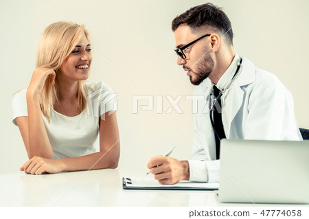 Male Doctor and Female Patient in Hospital Office 47774058