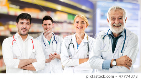 Doctor working in hospital with other doctors. 47774378