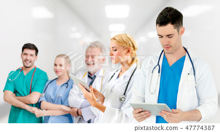 Doctor working in hospital with other doctors. 47774387