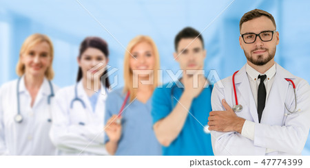 Doctor working in hospital with other doctors. 47774399