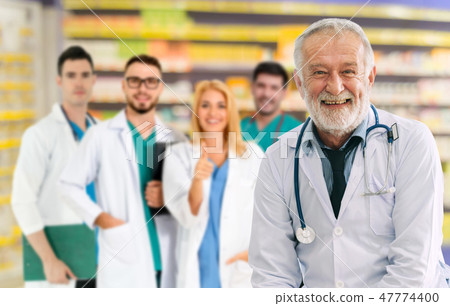 Doctor working in hospital with other doctors. 47774400