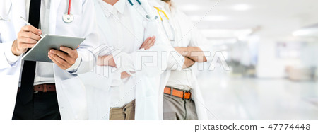Doctor working in hospital with other doctors. 47774448