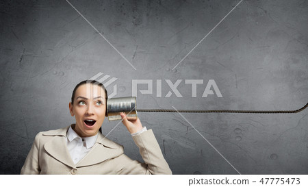 Woman using deaf phone Woman using deaf phone 47775473