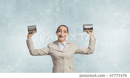 Woman using deaf phone Woman using deaf phone 47775476