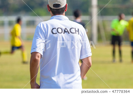 Back of football coach wearing white COACH shirt Back of football coach wearing white COACH shirt 47778364