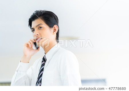 Male employee who calls a young businessman Male employee who calls a young businessman 47778680