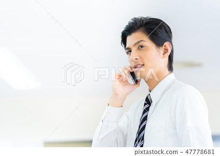 Male employee who calls a young businessman Male employee who calls a young businessman 47778681