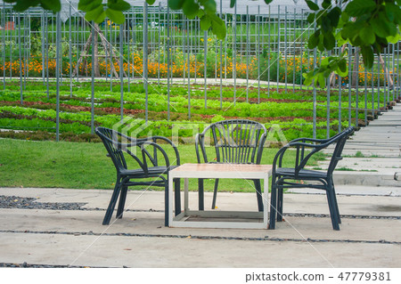 Three black wooden chair and one table. 47779381