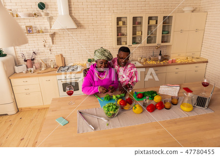 Delighted joyful couple enjoying cooking lunch together 47780455