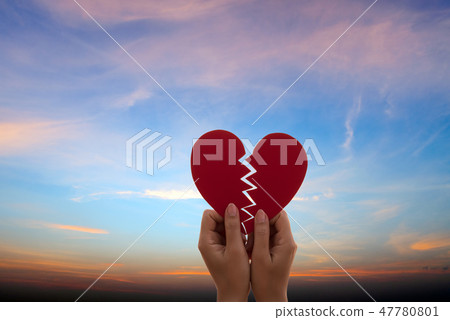 Woman hand holding broken paper red heart Woman hand holding broken paper red heart 47780801