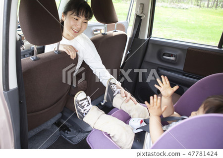Baby sitting on a child seat 47781424