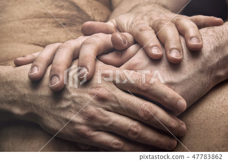 Two guys holding hands together. Couple in love 47783862