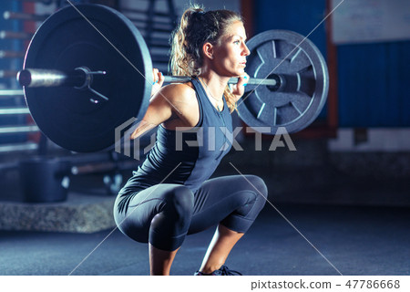 Woman weightlifting on training Woman weightlifting on training 47786668