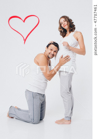 the husband embraces the pregnant wife the husband embraces the pregnant wife 47787461