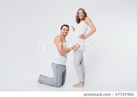 the husband embraces the pregnant wife the husband embraces the pregnant wife 47787466