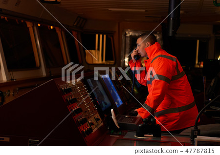Navigation officer. Pilot on a bridge of a vessel. Navigation officer. Pilot on a bridge of a vessel. 47787815