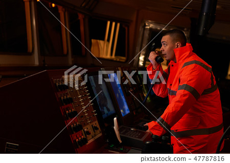 Navigation officer. Pilot on a bridge of a vessel. Navigation officer. Pilot on a bridge of a vessel. 47787816