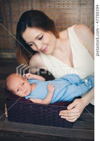baby in the arms of the mother. Woman holding a child baby in the arms of the mother. Woman holding a child 47788394