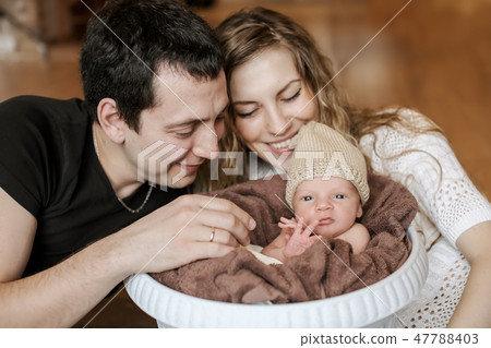 the baby on the hands of parents the baby on the hands of parents 47788403