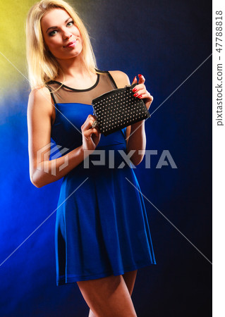 Elegant woman holds black handbag 47788818
