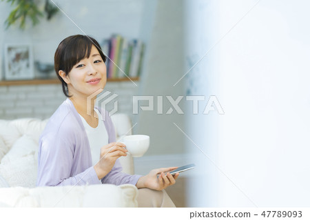 Mother using a smart phone middle woman full-time housewife 47789093