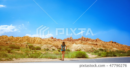 girl standing on the road with her back girl standing on the road with her back 47790276