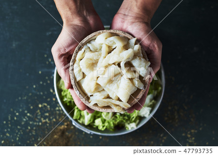 man preparing xato, catalan salad with raw cod man preparing xato, catalan salad with raw cod 47793735