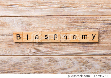 BLASPHEMY word written on wood block.  47793782