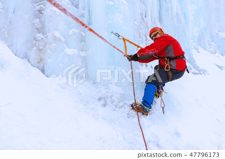 climber moves traverse the ice wall climber moves traverse the ice wall 47796173