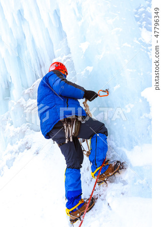 ice climber checks the reliability of the anchor ice climber checks the reliability of the anchor 47796349