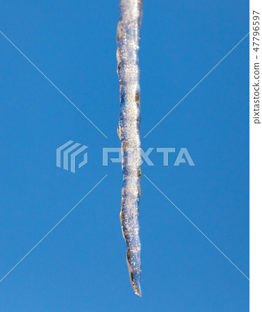 Icicle against the blue sky in winter Icicle against the blue sky in winter 47796597