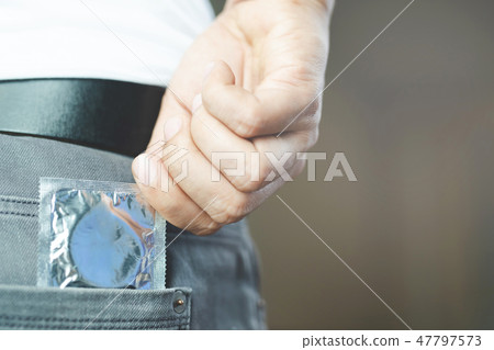 Condom man ready to use in Jeans pocket 47797573