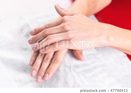 woman hands showing manicure after professional nail treatment in salon . woman hands showing manicure after professional nail treatment in salon . 47798415