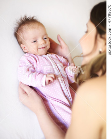 Young mother holding her newborn child. Young mother holding her newborn child. 47798670
