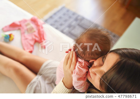 Young mother holding her newborn child. Young mother holding her newborn child. 47798671